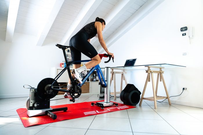 A woman on an indoor trainer in her home.