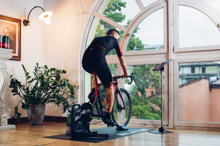 A man on an indoor training bike in his home.
