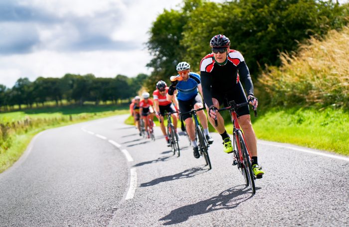 Cyclists racing up a hill.