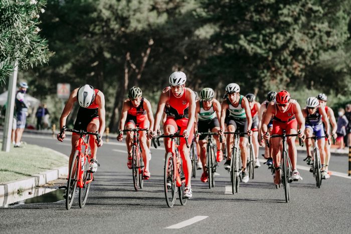 A cycling street race taking place on a sunny day.